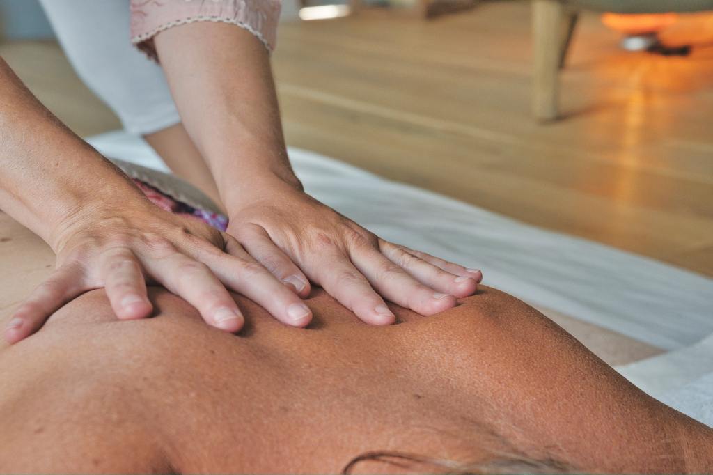 women on massage table doing body work